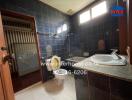 Bathroom with dark tiles and a shower area