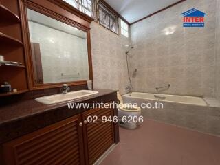 Bathroom with sink, mirror, and bathtub