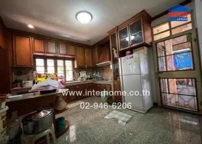 Spacious kitchen with wooden cabinets and modern appliances