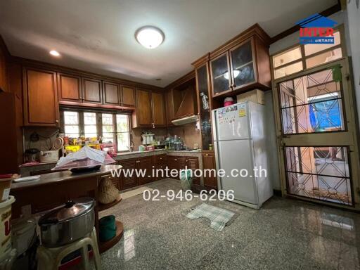 Spacious kitchen with wooden cabinets and modern appliances