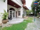 Outdoor view of a house entrance with potted plants and bicycle