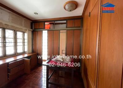 Bedroom with wooden furniture and windows