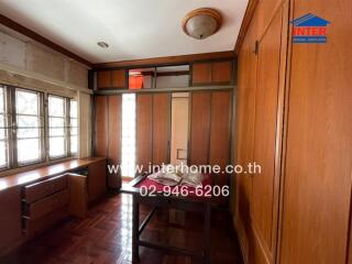 Bedroom with wooden furniture and windows