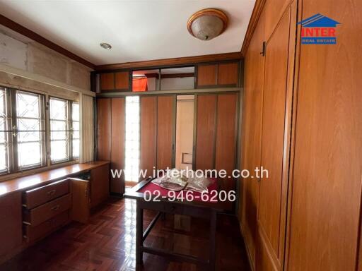 Bedroom with wooden furniture and windows