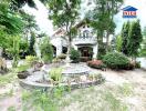 Front view of a residential property with garden and fountain