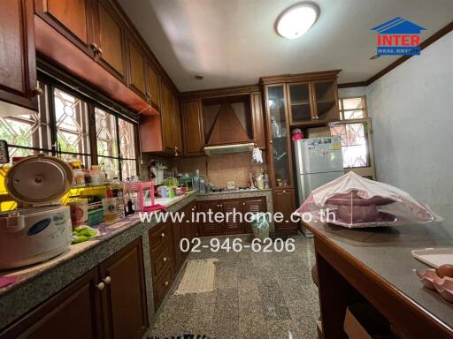 Spacious kitchen with wooden cabinets and modern appliances