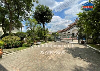 Front yard with gated entrance and garden