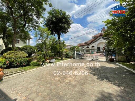 Front yard with gated entrance and garden