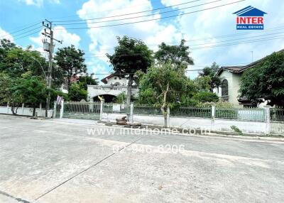 Exterior view of a residential property with trees and street