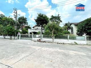 Exterior view of a residential property with trees and street