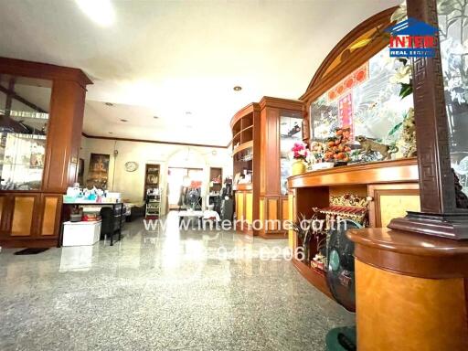 Spacious living room with ample natural light and elegant wooden decor