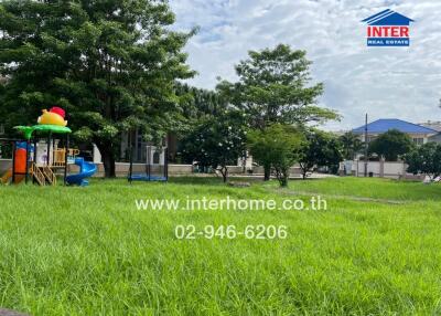 Spacious outdoor area with playground and lush greenery