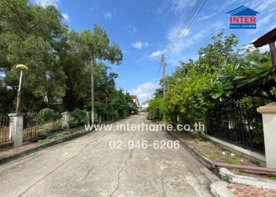 A view of the neighborhood street with greenery and homes