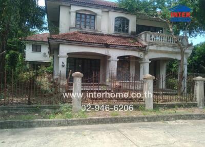 Front view of a two-story house with a fence