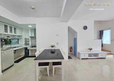 Modern kitchen and dining area with clean white decor