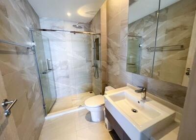 Modern bathroom with glass shower enclosure and large mirror