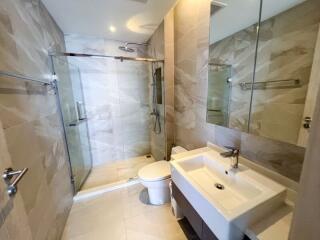 Modern bathroom with glass shower enclosure and large mirror