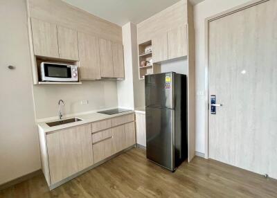 Modern kitchen with wooden cabinets and stainless steel appliances