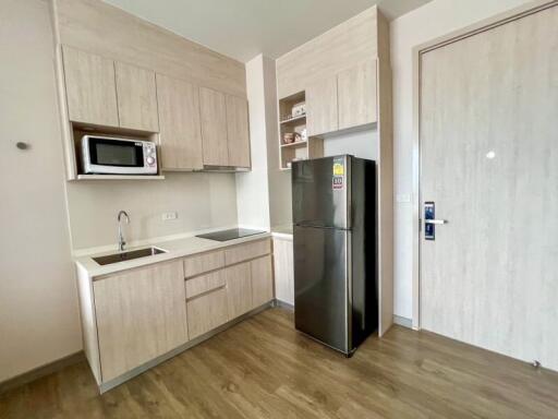 Modern kitchen with wooden cabinets and stainless steel appliances