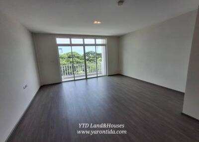 Spacious living room with large windows and balcony