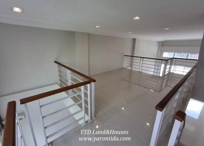 Spacious second-floor landing with railings and large windows