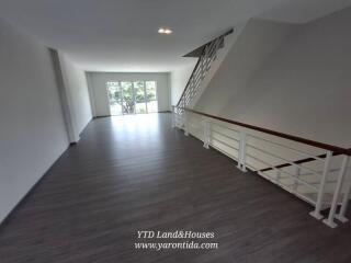 Spacious living area with large windows and modern flooring