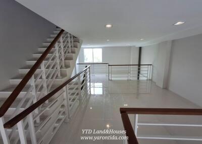 Staircase with modern railing in a spacious area