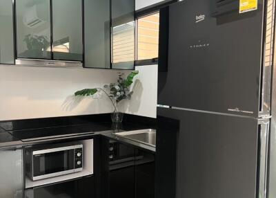 Modern kitchen with black appliances and white countertops