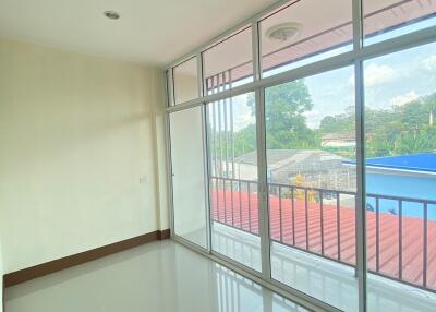 Empty room with large windows and a balcony view