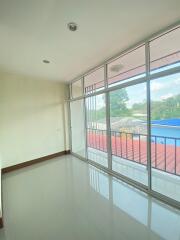 Empty room with large windows and a balcony view