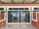 Covered patio area with tile flooring and sliding glass doors