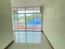 Empty living room with large windows and balcony view