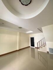 Spacious empty living room with staircase