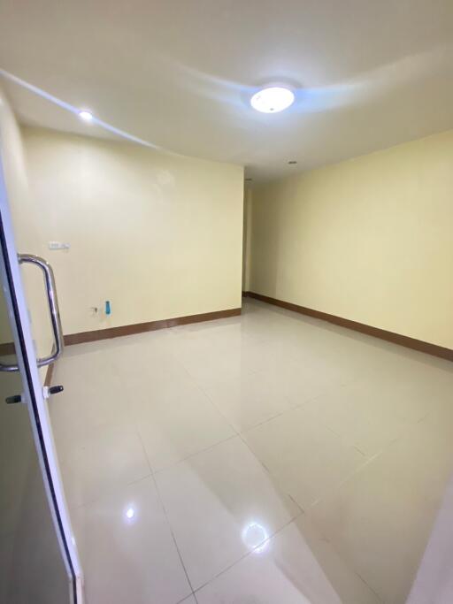 Empty room with tiled floor and ceiling light