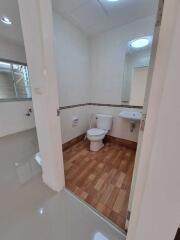 Bathroom with wooden floor tiles and sanitary fixtures