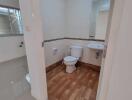 Bathroom with wooden floor tiles and sanitary fixtures