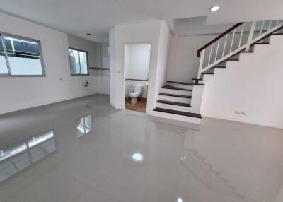 Spacious living area with a staircase and attached bathroom