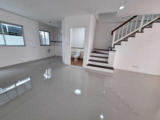 Spacious living area with a staircase and attached bathroom