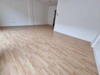 Spacious empty living room with wooden flooring