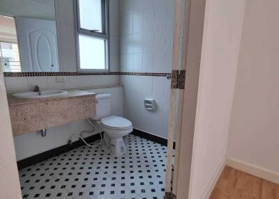 Bathroom with tiled floor and wall-mounted sink