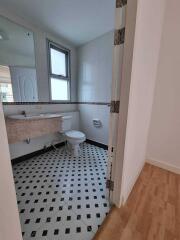 Bathroom with tiled floor and wall-mounted sink