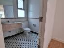 Bathroom with tiled floor and wall-mounted sink