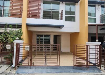 Front view of a modern townhouse with a small driveway