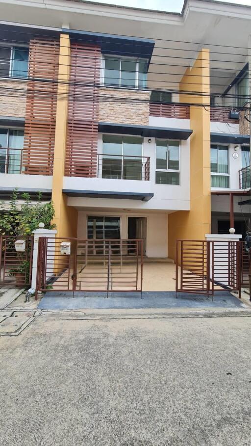 Front view of a modern townhouse with a small driveway