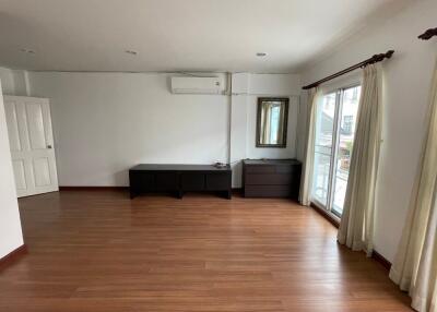 Spacious unfurnished living room with wooden flooring and large window