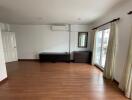 Spacious unfurnished living room with wooden flooring and large window