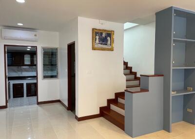 Interior view showing stairs, a small kitchen, and part of the living area