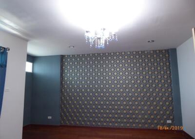 Living room with feature wall and chandelier