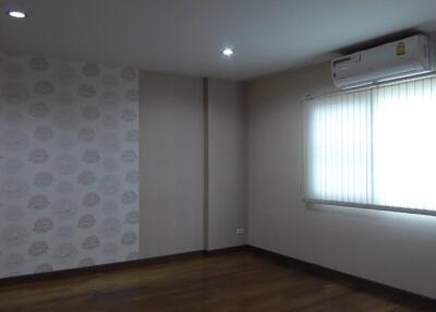 Spacious bedroom with air conditioning and window blinds