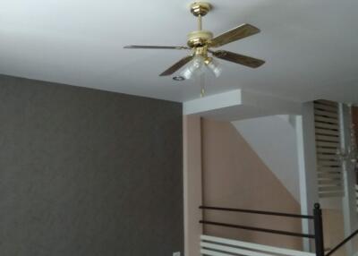 Living room with ceiling fan and wooden flooring